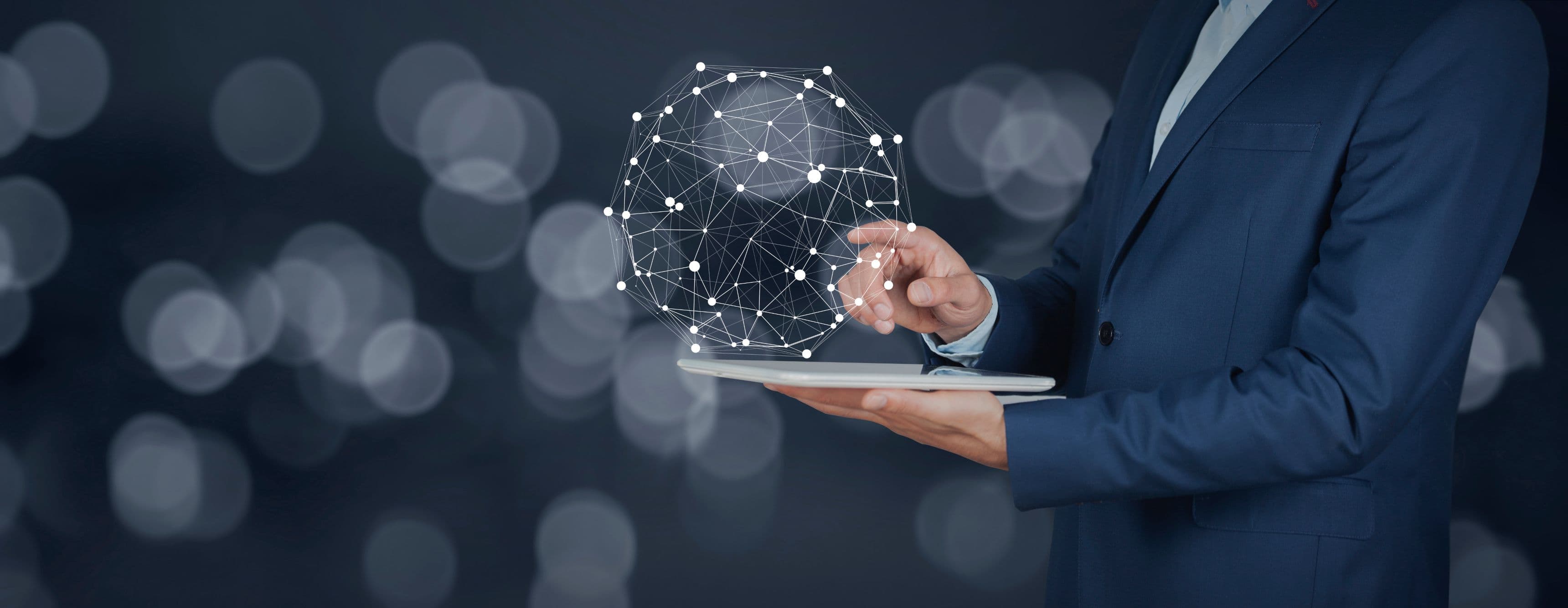 Professional interacts with a glowing digital network sphere projected from a tablet.