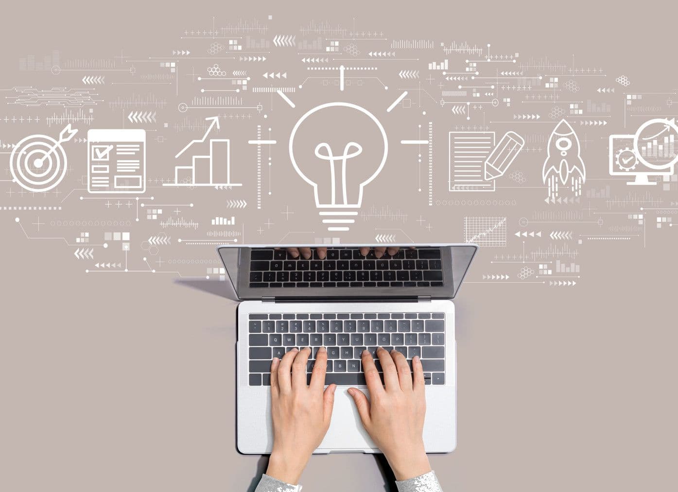 Person typing on a laptop with a glowing lightbulb surrounded by business and idea icons.